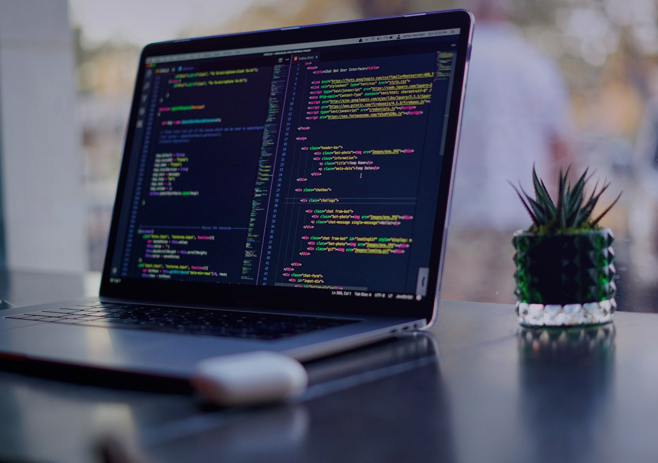 Realistic developer workspace with a laptop showing code for CMS API handoff