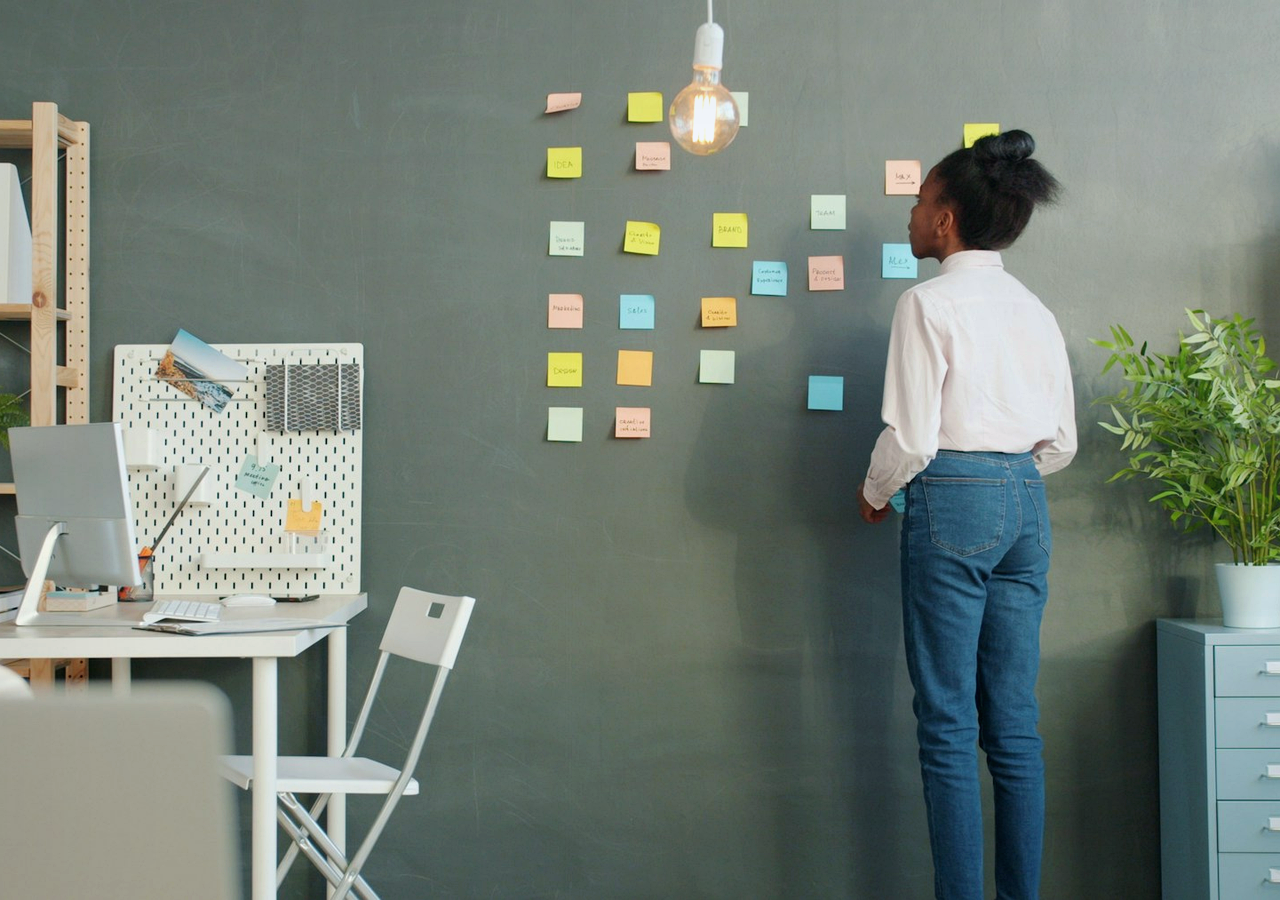 Realistic office wall with sticky notes arranged for content planning and publishing workflow